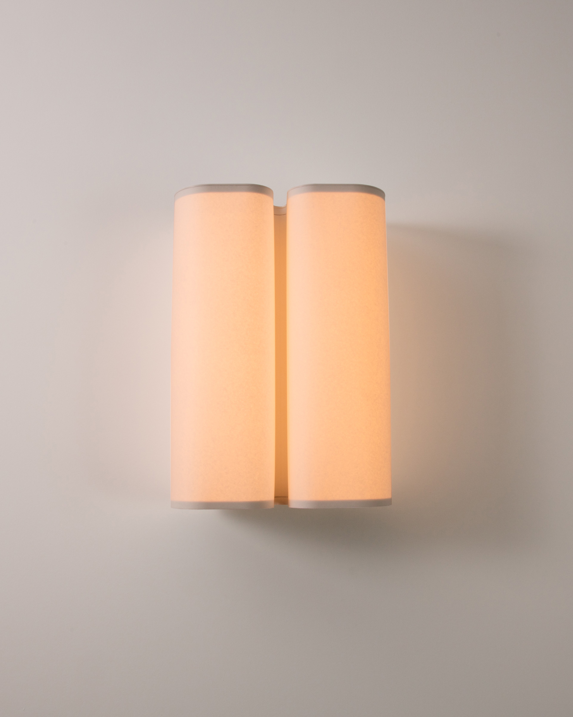 The Brasilia A sconce by Michel Boyer emits a warm light thanks to its white paper diffuser