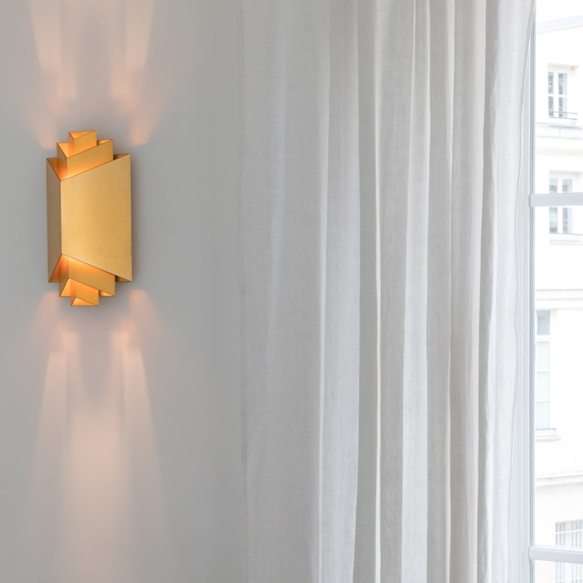 Phénix sconce designed by Joseph Dirand for Ozone next to a