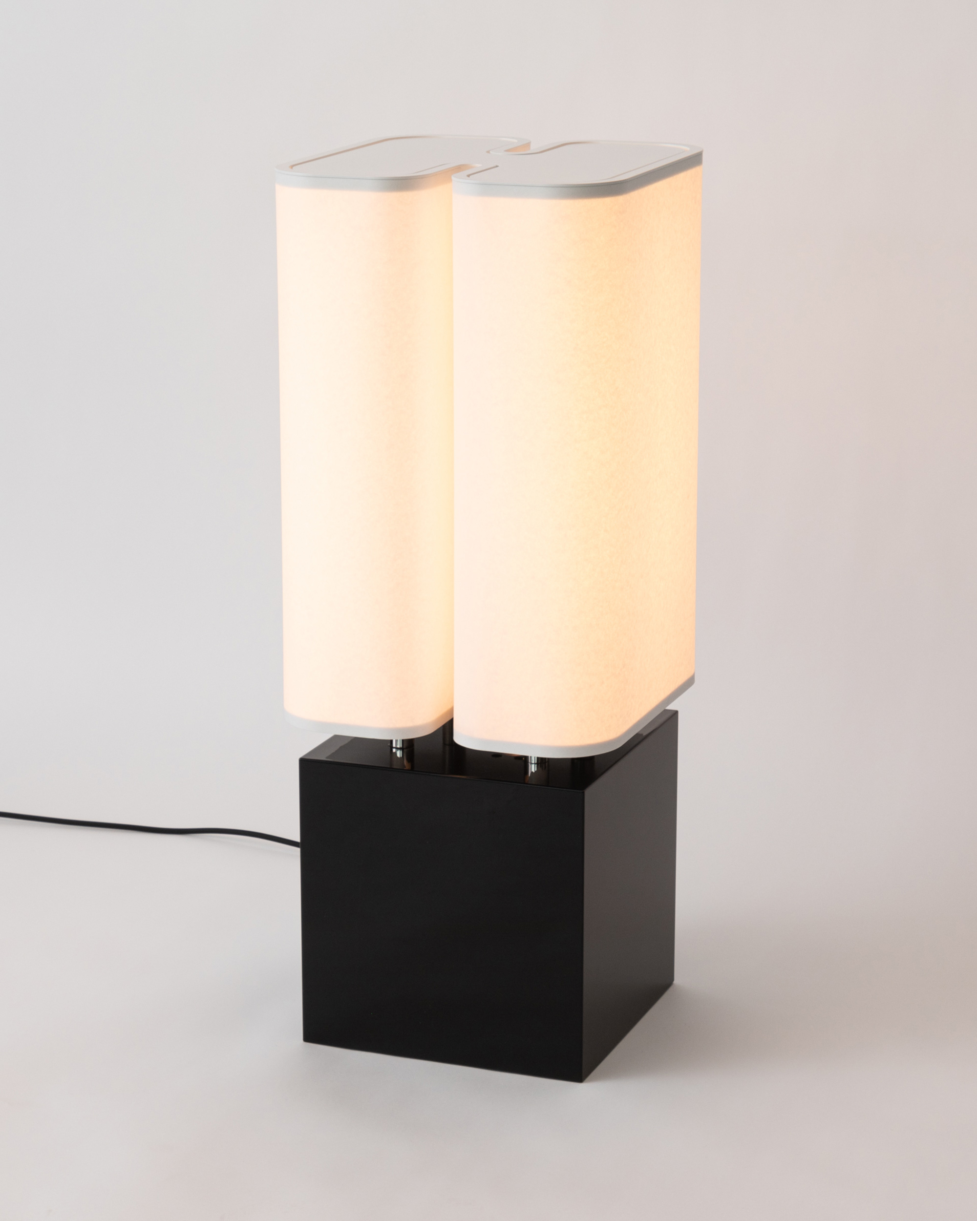 Brasilia LP table lamp by Michel Boyer for Ozone with a glossy black base and a paper diffuser