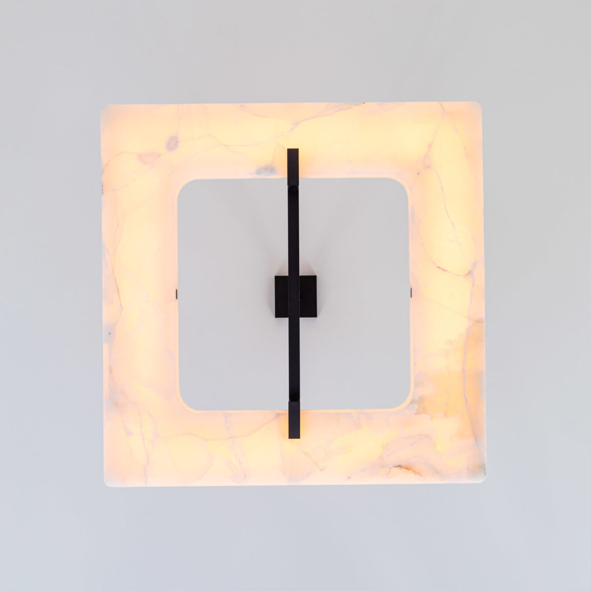 Low-angle shot of the Embrun L Gounot & Jähnke square chandelier in white onyx and dark patinated brass
