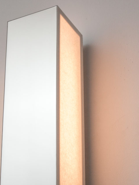 Close-up on the different paper and mirror nickel finish surfaces of the Line V wall lamp by Étienne Gounot and Éric Jähnke for Ozone