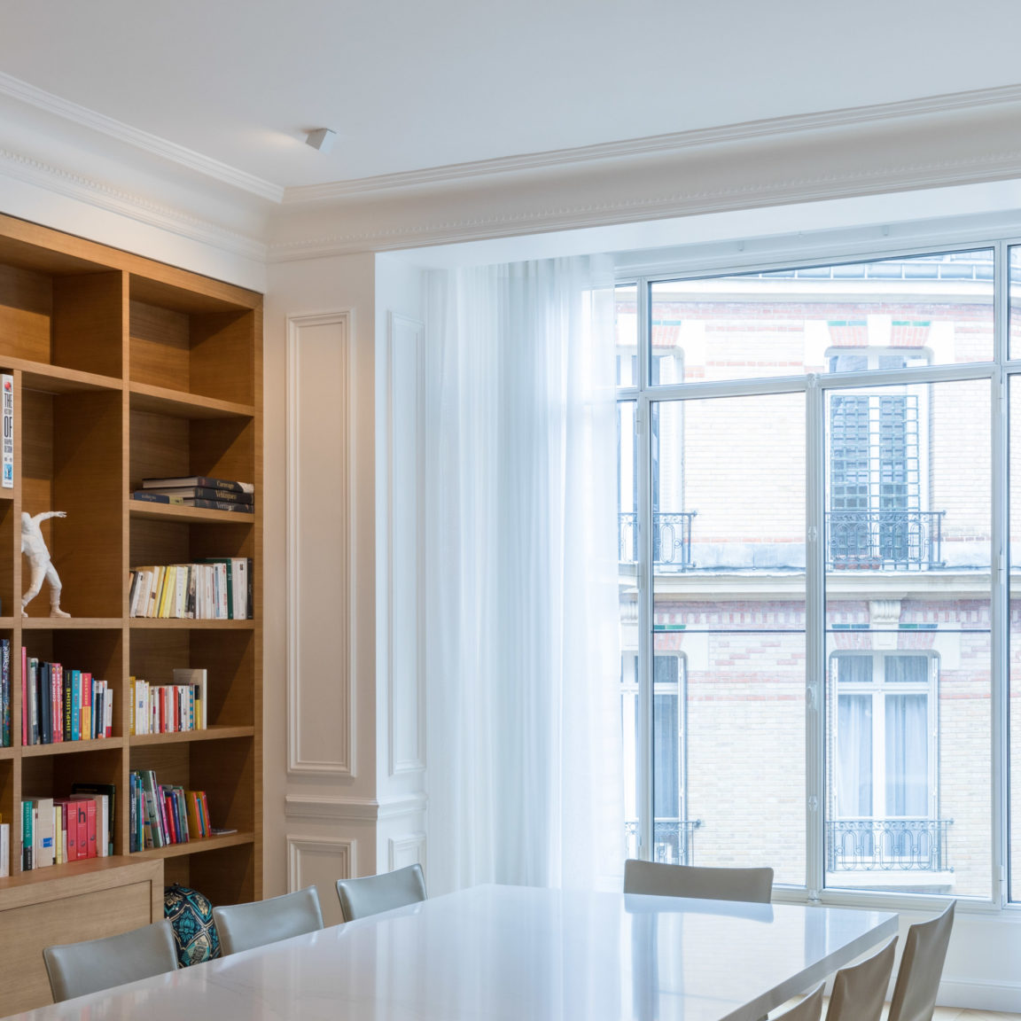 The Marienbad SW60 spotlight illuminates a wooden bookcase facing a bay window