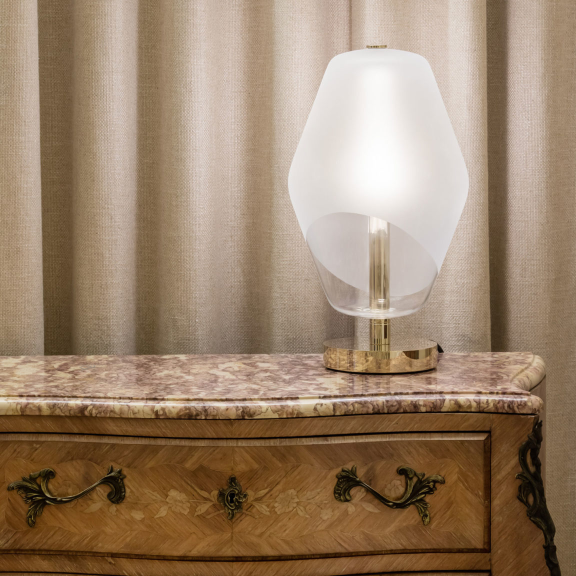 The Saint-Germain table lamp by Régis Botta on a wooden and marble chest of drawers