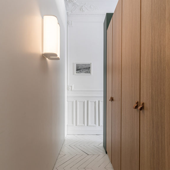 Brasilia A sconce by Michel Boyer for Ozone in the hallway of Appartement Lumière which is fully lit by Ozone.