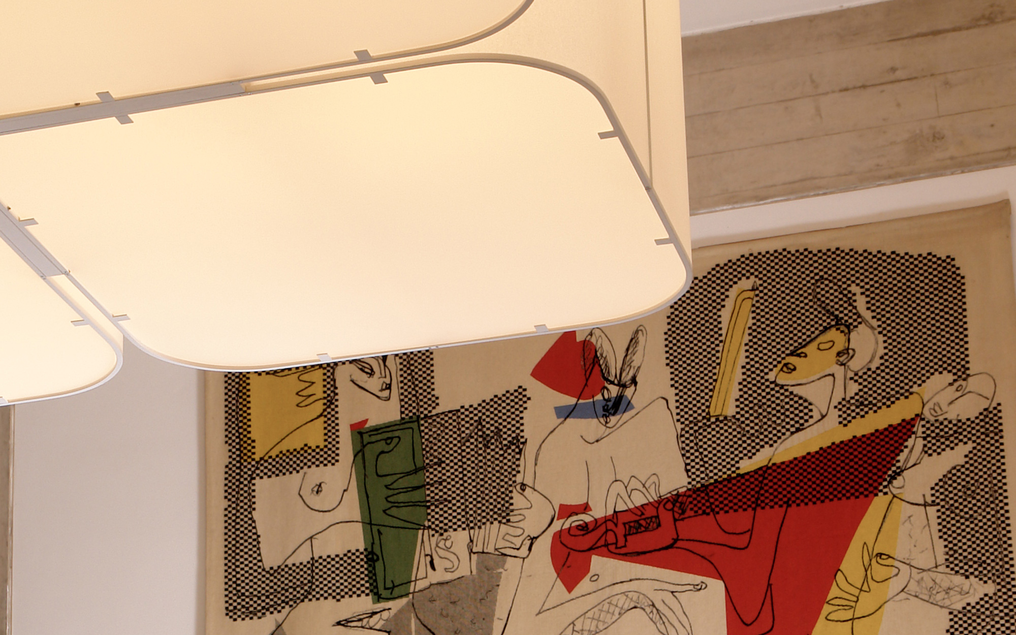 The paper diffuser of the Brasilia L chandelier by Michel Boyer casts a soft, warm light on a painting by Le Corbusier