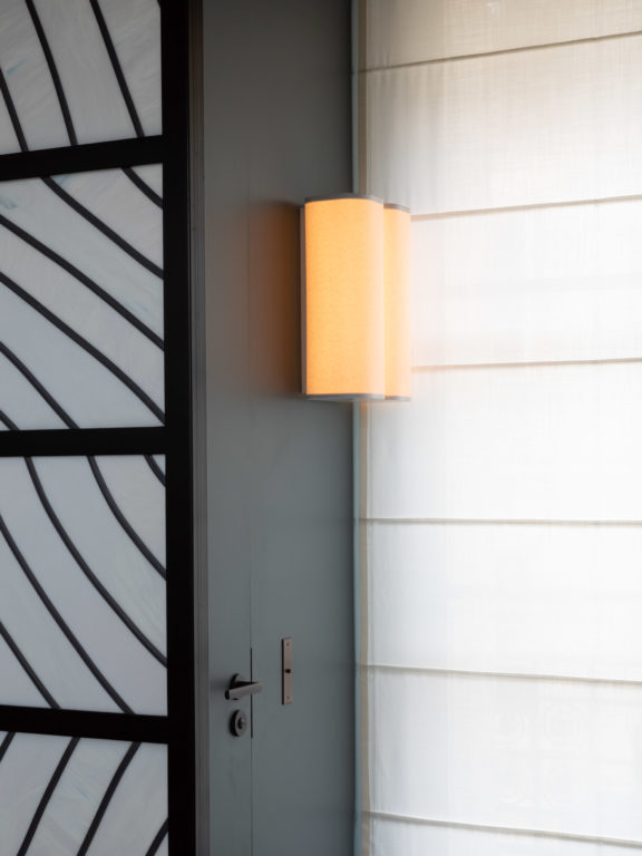 Brasilia A sconce by Michel Boyer on a matte black wall
