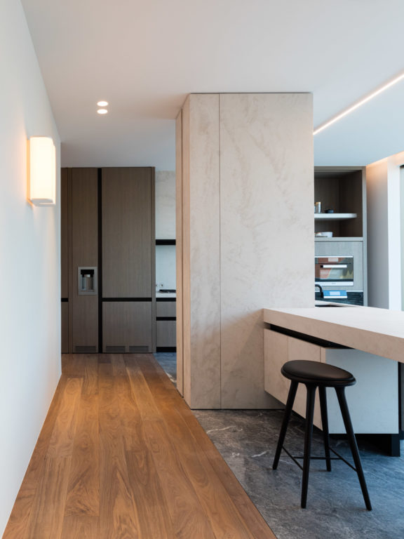 The Brasilia A sconce by Michel Boyer diffuses light in a modern kitchen thanks to its paper diffuser