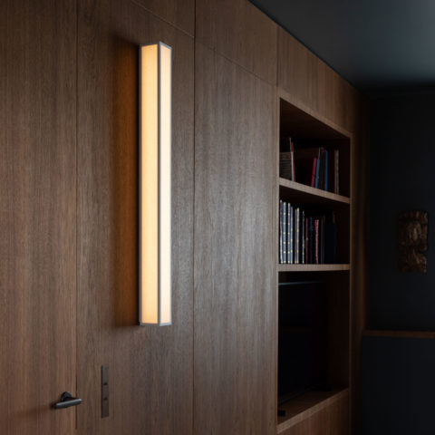 The Line L wall lamp by Gounot & Jähnke in a wood architectural room
