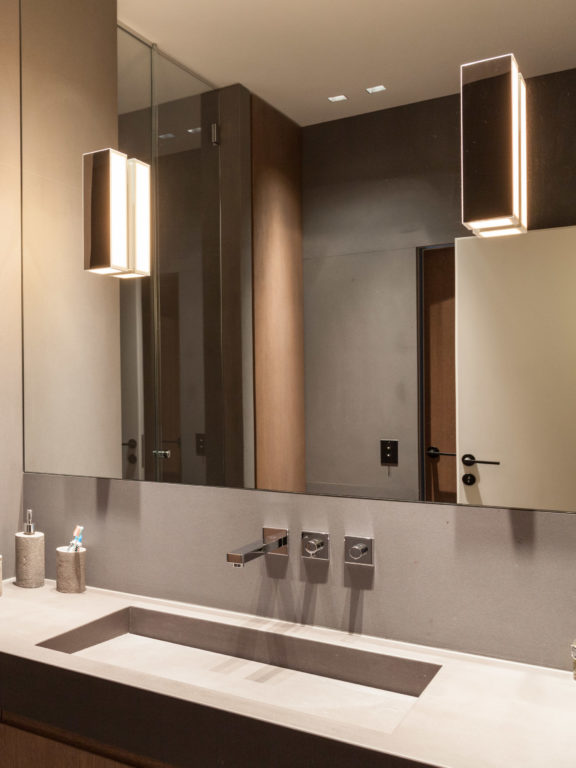 Two Line V wall lights by Gounot & Jähnke on either side of a bathroom mirror