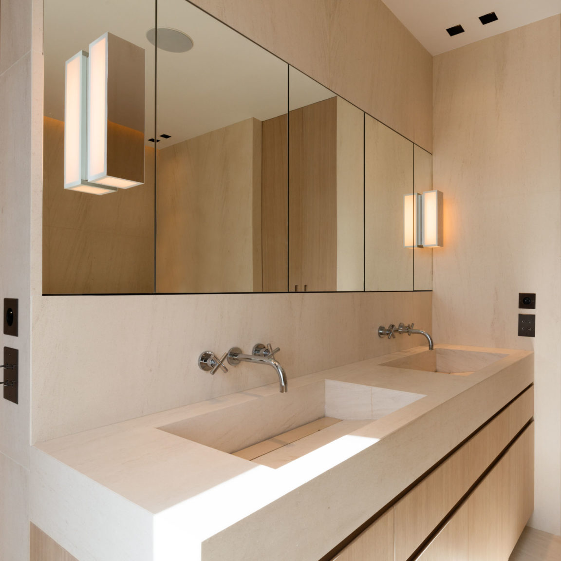 Two Line V wall lights by Gounot & Jähnke on either side of a bathroom mirror