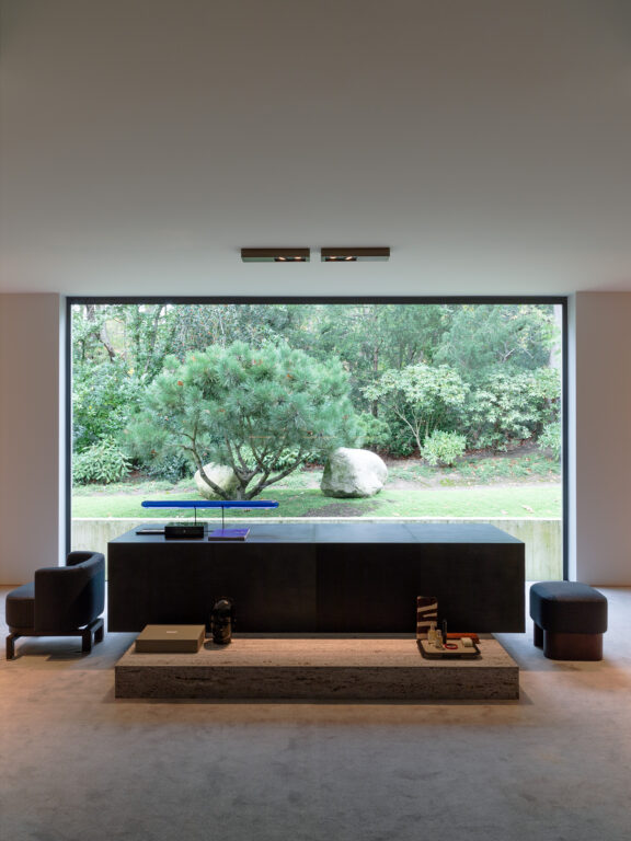 Two Regard S ceiling lights illuminate a coffee table in front of a bay window