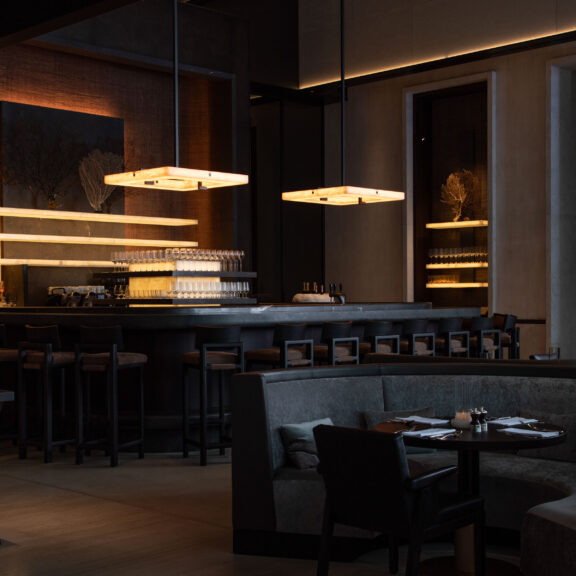 Embrun L chandeliers illuminate the reception area of La Réserve Resort in Knokke-Heist, Belgium