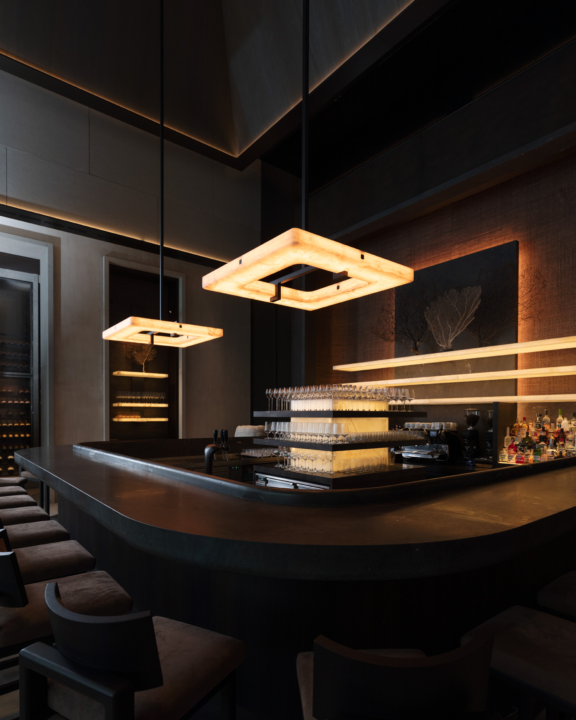 Embrun L chandeliers illuminate the reception area of La Réserve Resort in Knokke-Heist, Belgium