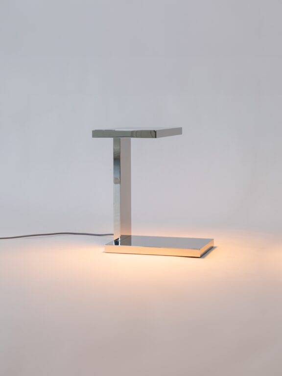 Die Tischleuchte Furtiv LP von Lauriot-Prévost und Perrault aus verspiegeltem Nickel beleuchtet das weiße Dekor, in dem sie sich befindet.