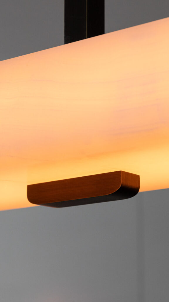 Close-up of the dark patinated brass and softened white onyx of the Embrun PL chandelier by Gounot & Jähnke