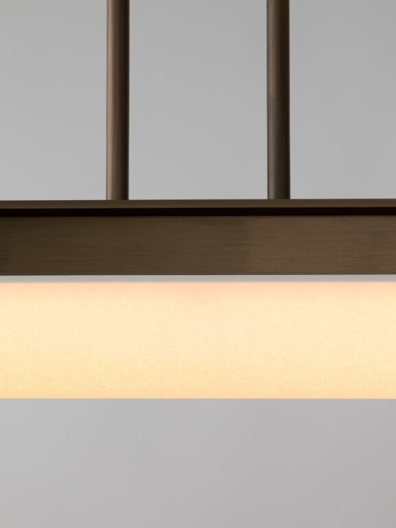 Focus on the white diffuser paper and matte bronze finish of Glenn Sestig's Tennessee PL1 pendant light for Ozone