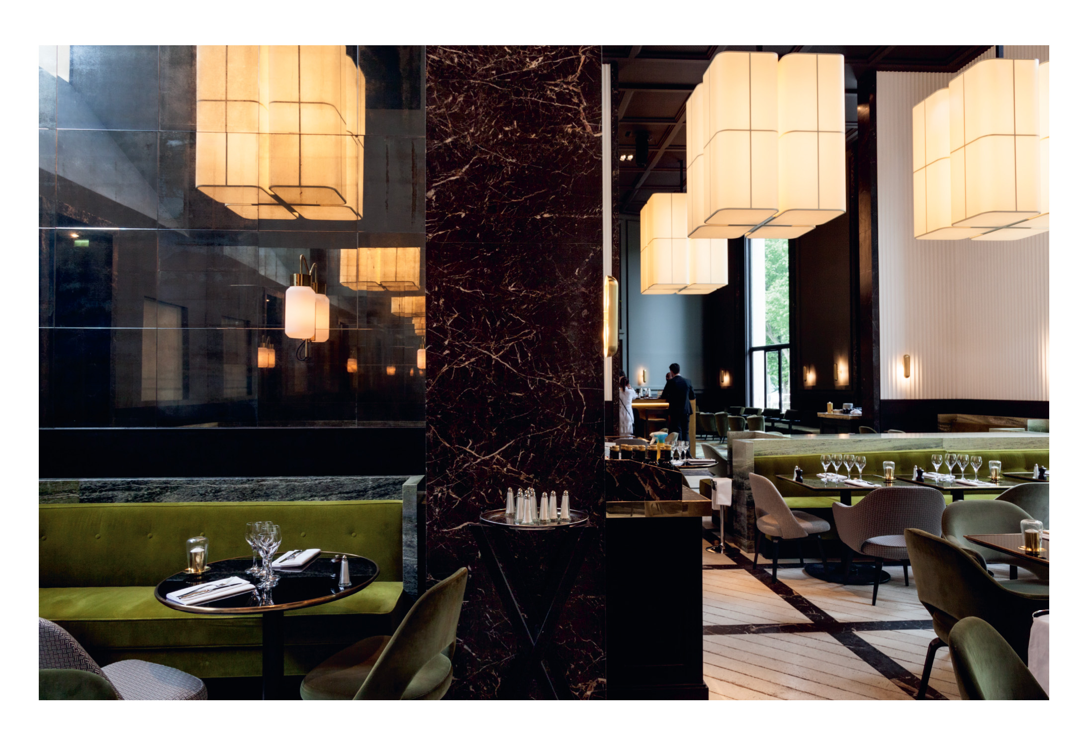 Double page spread from the Brasilia booklet featuring Brasilia L lamps in the interior of the Monsieur Bleu restaurant in Paris