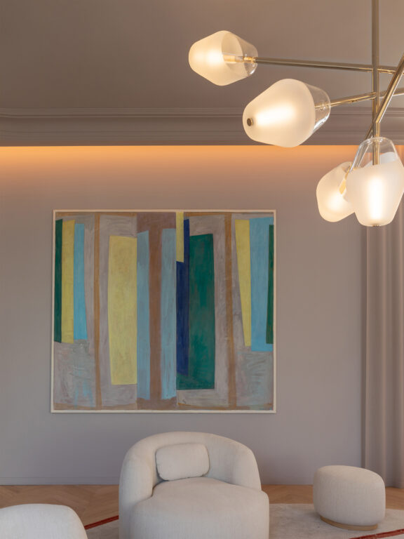 Part of the Opéra chandelier with blown glass globes from Régis Botta's Les Parisiennes collection illuminating a colorful painting