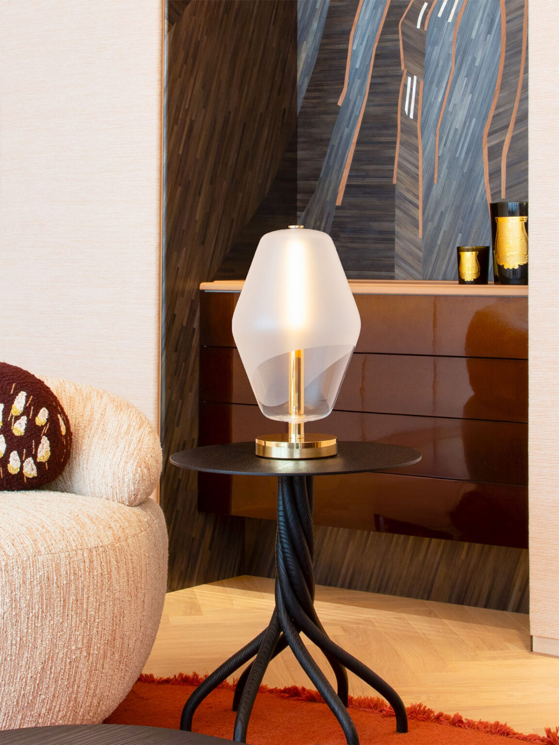 The Saint-Germain table lamp with a blown glass globe from Régis Botta's Les Parisiennes collection illuminates the living room