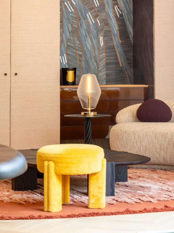 Saint-Germain table lamp with blown glass globe from the Les Parisiennes collection by Régis Botta in a living room with tables and sofa