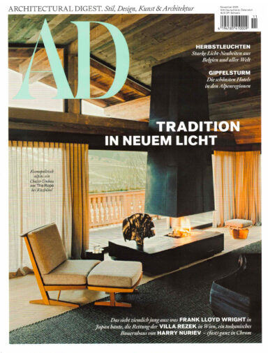 Cover of the November issue of Architectural Digest Germany. It shows a living room in a mountain chalet.