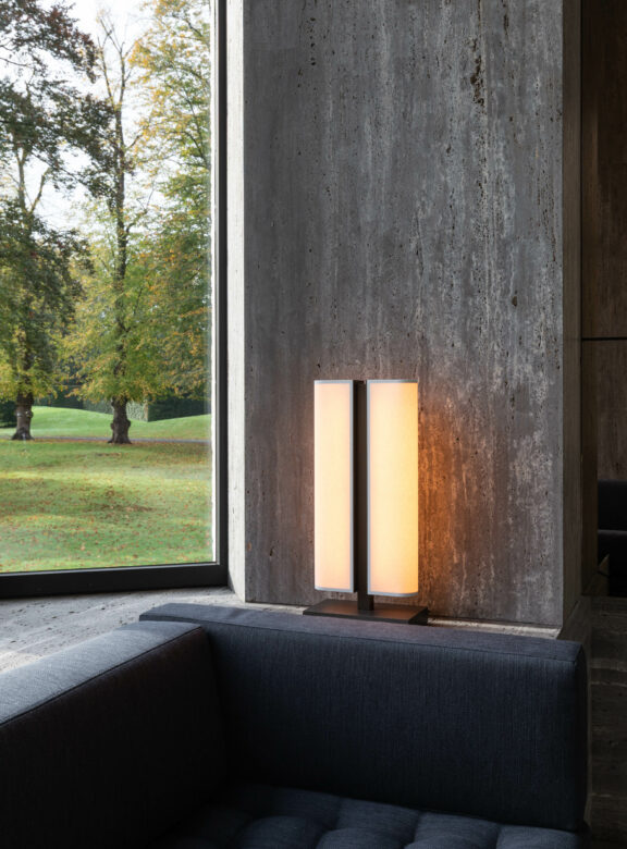 Tennessee LP table lamp in front of a bay window in a dark villa.