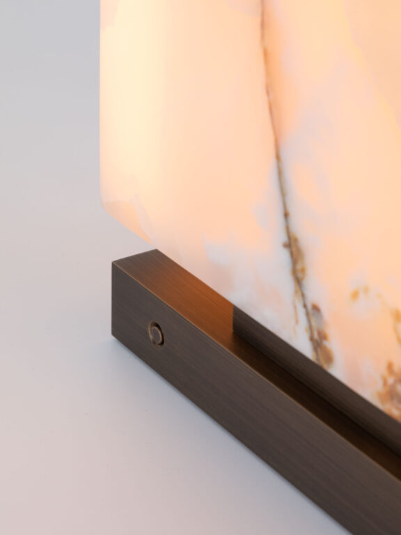 Close-up of the switch on the base of the Embrun LP table lamp in white onyx
