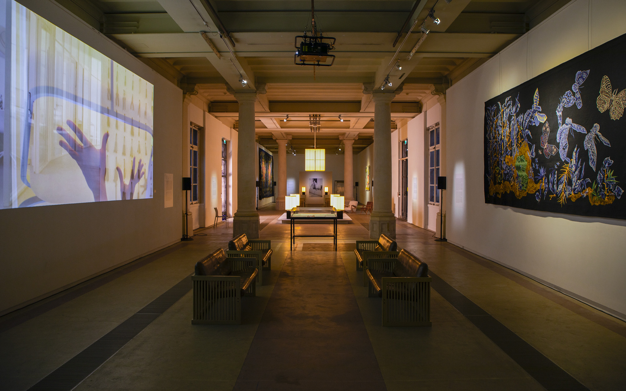 Exhibition design to celebrate the 50th anniversary of the Brasilia collection, featuring several pieces from the collection—including the chandelier, the floor lamp, and the table lamp—as well as tapestries inspired by the Brasilia theme displayed on the walls of the Galerie des Gobelins in Paris